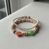 Handmade 2-Piece Bracelet Set with White Beads, Orange & Green Accents, Flower & Smiley Charms – Gift Jewelry, Boho Chic Style