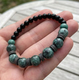 Handmade Boho Bracelet – Greenish-Gray Speckled K2-Style Beads with Dark Spacer Accents & Gray Heishi