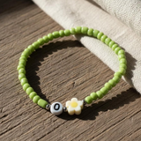 Green Seed Bead Daisy Bracelet with Initial O, Cute Personalized Stretch Jewelry, Symbol of Growth & Happiness Gift