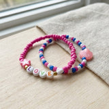 Handmade Love & Shell Beaded Friendship Bracelet Set (2 pcs) – Pink Star, Pastel Shell Charm & Letter Beads “LOVE,” Playful Jewelry Gift for Kids/Teens