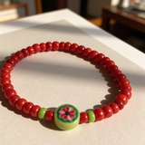 Handmade Red Beaded Bracelet, Green Accents, Floral Centerpiece Playful Boho Jewelry