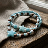 Handmade Beaded Friendship Bracelet – Light Blue & White Beads with Brown Accents, Two Blue Star Beads, Playful Gift for Kids/Teens