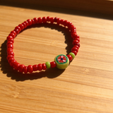 Handmade Red Beaded Bracelet, Green Accents, Floral Centerpiece Playful Boho Jewelry