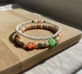 Handmade 2-Piece Bracelet Set with White Beads, Orange & Green Accents, Flower & Smiley Charms – Gift Jewelry, Boho Chic Style